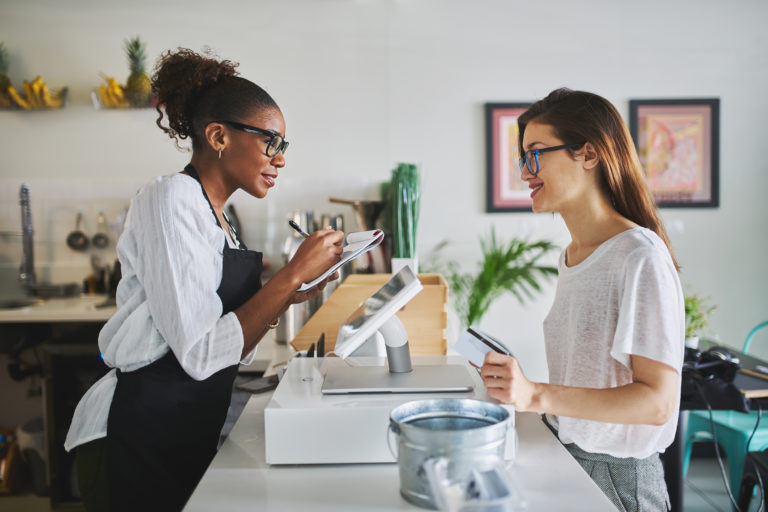 Cashier and customer at restaurant