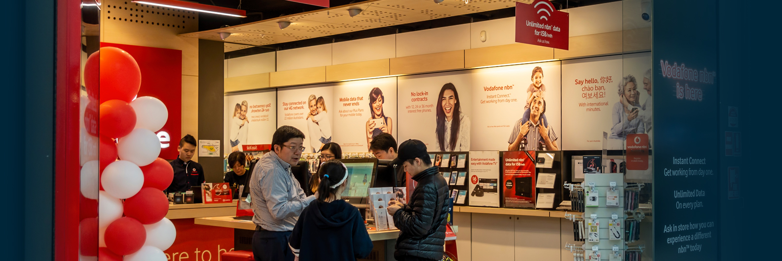 A busy wireless store with employees and customers.