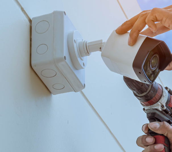 man installing security camera