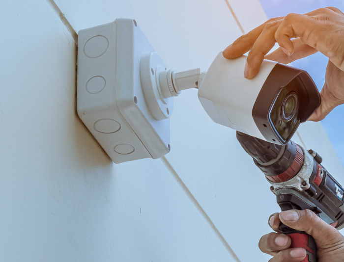 man installing security camera